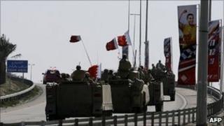 Bahraini armoured vehicles leave the area near Pearl Square - 19 February 2011