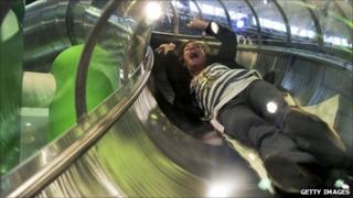 Participant slides down a tube at the Mobile World Congress in Barcelona