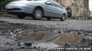 Car and pothole
