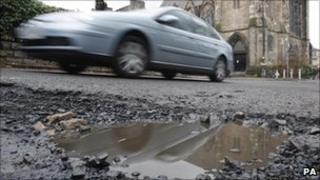 Car driving over potholes