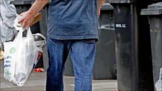 Man carrying bag of rubbish