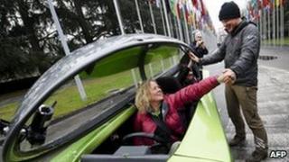 Team members on the Australian three-wheeler Trev celebrate the end of the trip in Geneva, 24 February
