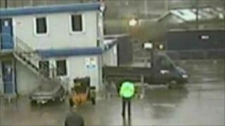 Footage of truck being reversed into building