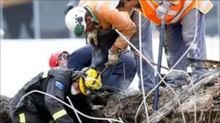 Rescue workers search through the CTV building site