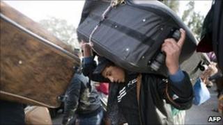 An Egyptian flees Libya at the Ras Jdir border post in Tunisia