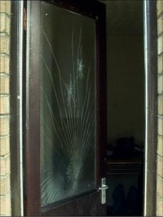 Door with two bullet holes in the glass