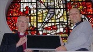 Lord Carey & Revd. Cowan display a PVC panel at the Church