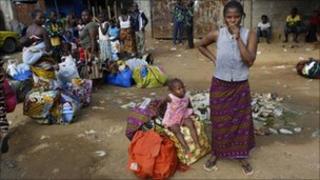 Abobo residents stand with their belongings, in Abidjan, Ivory Coast, 28 Feb 2011