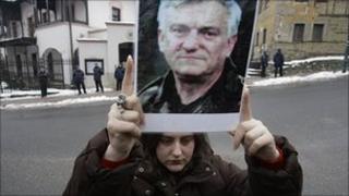 Protester holds picture of Jovan Divjak outside Austrian embassy in Sarajevo, Bosnia. 4 March 2011