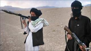In this file photo taken on September 26, 2008, fighters with Afghanistan's Taliban militia pose on a hillside at Maydan Shahr in Wardak province, west of Kabul