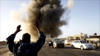 A rebel fighters reacts during an air strike in Ras Lanuf March 7, 2011