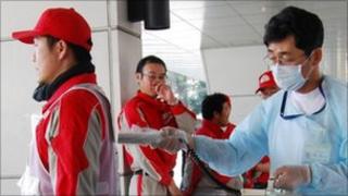 Red Cross worker being checked for radiation exposure