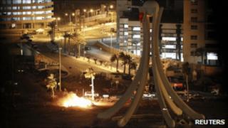 Burning tents are seen in a Manama square after forces evacuated anti-government protesters