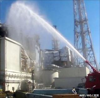 Firefighters pump water over a reactor unit at Fukushima Daiichi (Image: AFP/HO/JIJI)