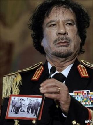 Col Gaddafi wears a picture depicting the execution of Omar al-Mukhtar in Rome in 2009