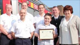 Jake Goode with his parents, joined by firefighters from Coulby Newham Fire Station