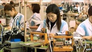 Workers assembling parts at Sony factory