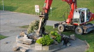 Workmen remove the base of the war memorial. Picture by Andre Cleiren from De Wase Koerier