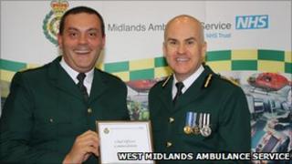 Mr Wheaton (left) being given an award by Anthony Marsh, chief executive of West Midlands Ambulance Service