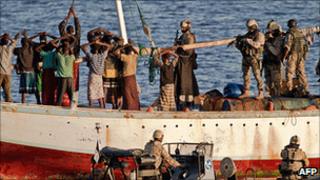 Finnish naval team approaching suspected pirates on a boat sailing off the coast of Oman