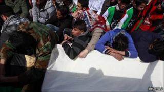 Mourners pray over the coffin of a man killed in the Nato air strike.