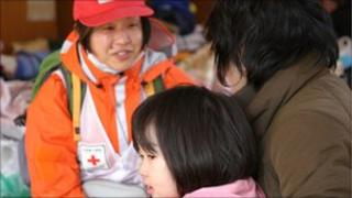 Member of the Japanese Red Cross Society helping people at evacuation centre. Picture supplied by British Red Cross.