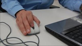 man using mouse and computer