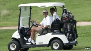 President Barack Obama in a golf cart with friend Mike Ramos in December