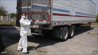 Morgue employee unloading bodies on 8 April, 2011
