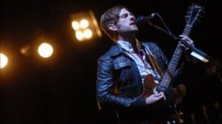 Caleb from Kings of Leon performing at Glastonbury in 2008