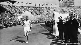 John Mark runs in the Empire Stadium, Wembley, with the torch