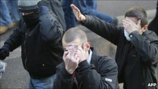Ultranationalists obscure their faces as they march in Moscow in 2005