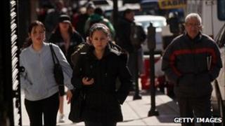 Hispanic residents walking down a city street in the state of New Jersey