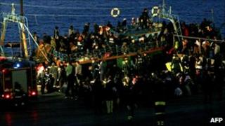 A boat carrying 600 migrants arrives in the port of Lampedusa on April 8, 2011