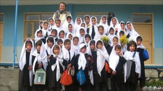 This 2005 photo provided by the Central Asia Institute shows Greg Mortenson, standing with schoolgirls from the Lalander village school, Char Asiab valley, central Afghanistan.