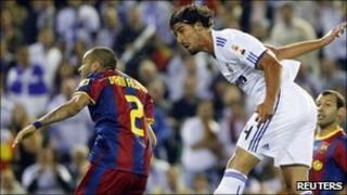 Real Madrid's Sami Khedira (R) fights for the ball with Barcelona"s Dani Alves