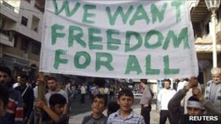 Boys hold a banner during a demonstration in the Syrian port city of Baniyas on 17 April 2011