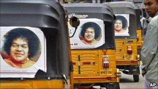 Rickshaws with pictures of Satya Sai Baba, in Puttaparti, India, April 2011