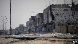 A man walks through Tripoli street in the besieged city of Misrata, 26 April 2011