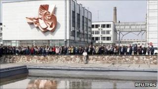 People attend a memorial ceremony at the now-defunct nuclear power plant in Chernobyl on Tuesday