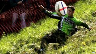 A competitor chases a Double Gloucester cheese down Coopers Hill, Gloucestershire