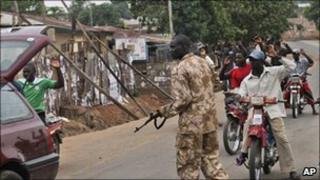 A soldier searches a car in Kaduna, Nigeria, Thursday, 21 April 2011