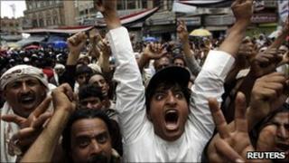 Anti-government protesters shout slogans during a rally to demand the ouster of Yemen's president