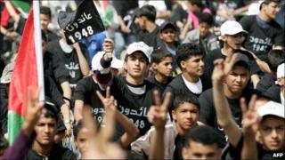 Palestinian youths flash at a rally in the West Bank city of Jenin