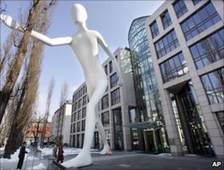The sculpture Man Walking by US artist Jonathan Borofsky stands in front of the headquarters of Munich Re AG in Munich, March 2006