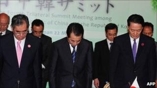 Japanese Prime Minister Naoto Kan, centre, at trilateral talks. 22 May