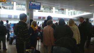 People queue with luggage
