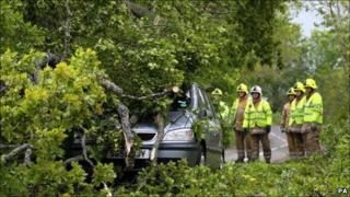 Emergency services tend to a car trapped by a fallen tree near Dunblane