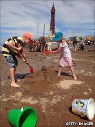 Children make sand castles on Blackpool beach