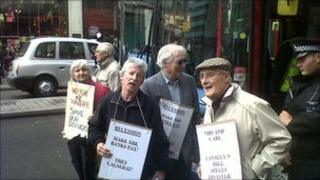 Protesters standing in front of a London bus